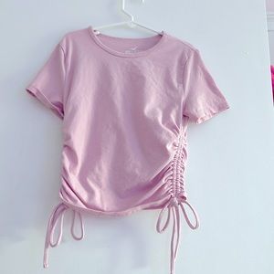This is a pink kind of cropped shirt